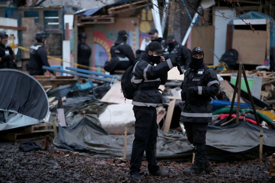 Police enforcement officers move in to the encampment in Euston Square Gardens