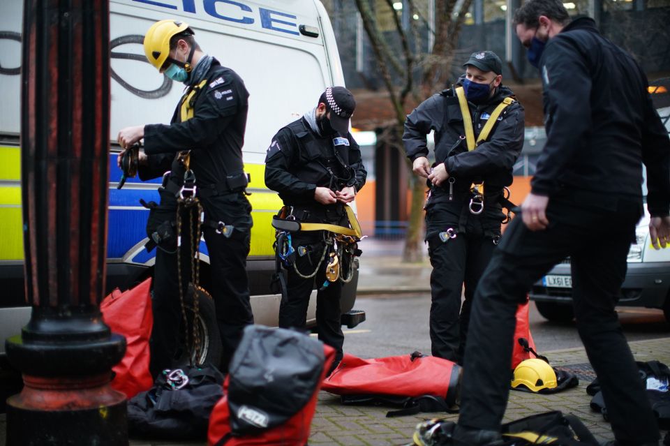 Officers can be seen preparing to take down the tree houses