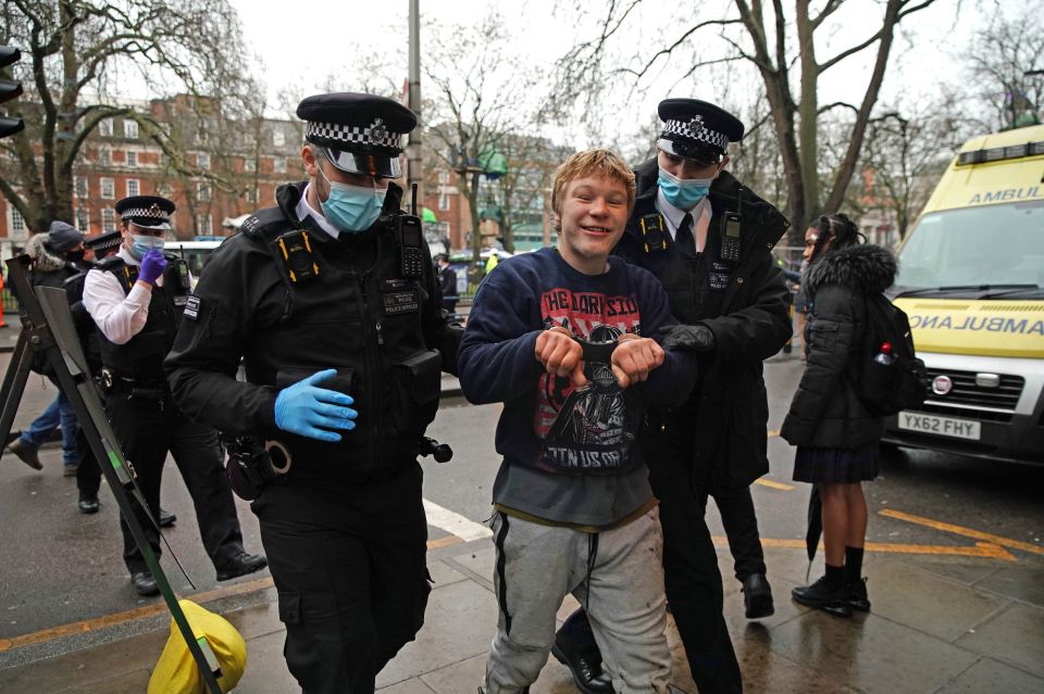 A man is led away after being evicted