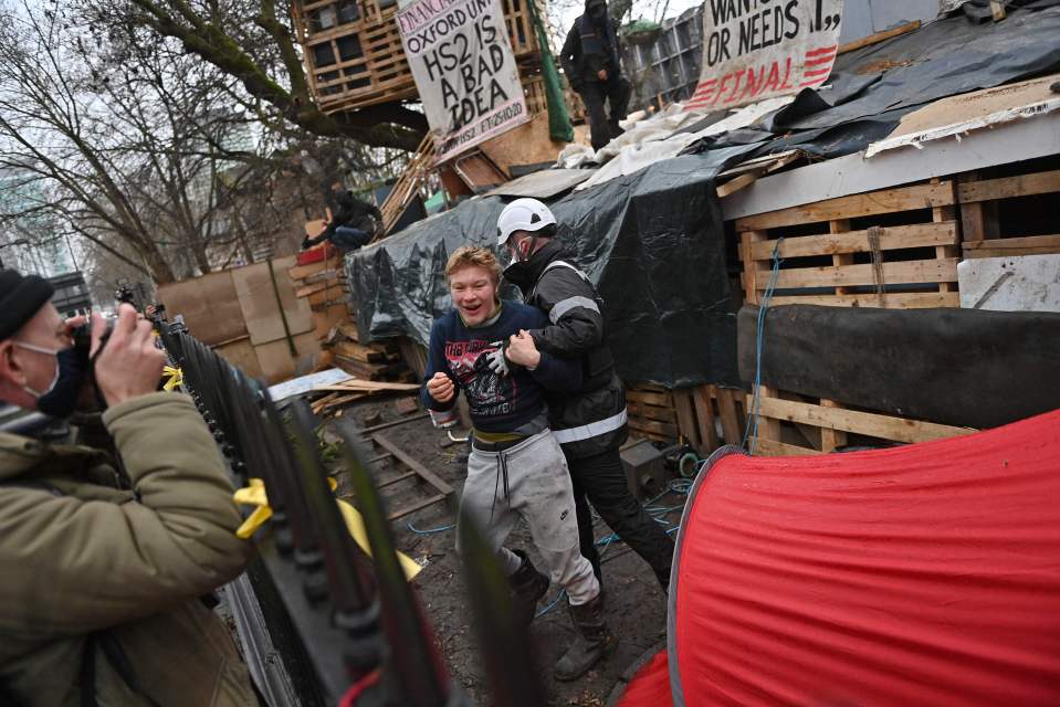 The demonstrator could be heard shouting as he was carried out from the makeshift camp