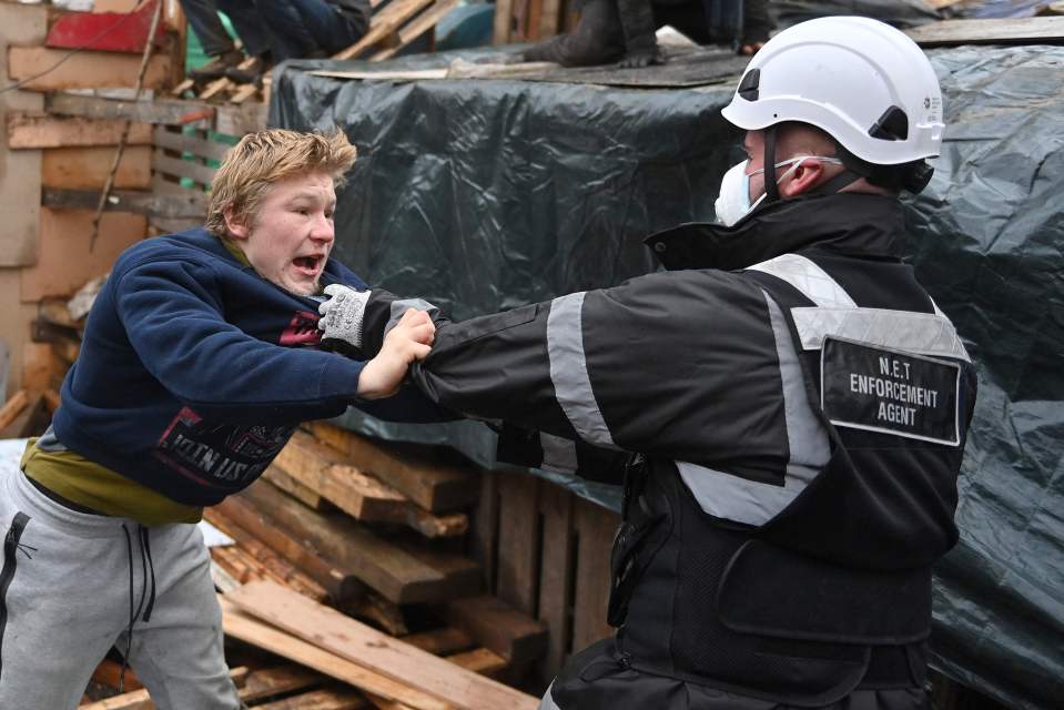 A protester tussling with an enforcement agent