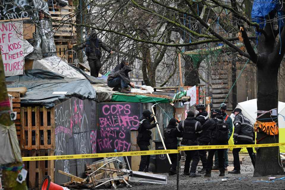 Bailiffs cut through the rope strung up at the site