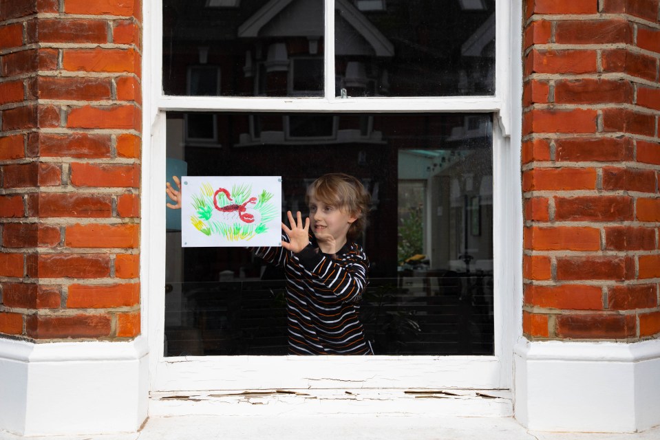 Laurence puts his piece up in the window at home