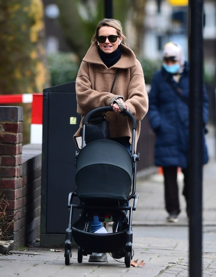 The doting mum looked radiant as she pushed her son around North London