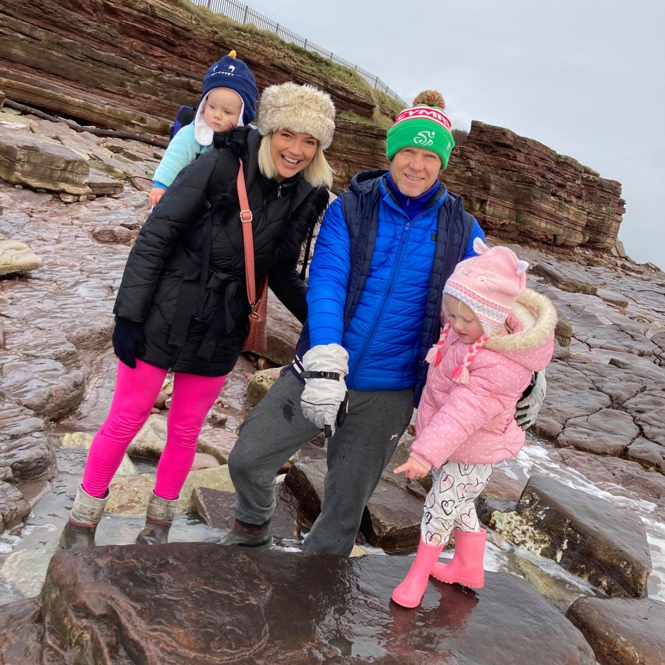 Lily (right) spotted the 220 million-year-old dinosaur footprint on a beach in South Wales. Pictured: Lily with her family. Dad Richard (right), mum Sally (left) and her baby brother