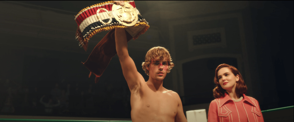 Justin Bieber holds up a boxing title at the climax of the video 