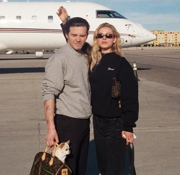 The Peltz family are reported to have helicopters and two private jets. Above, Brooklyn and Nicola pose in front of what looks like a private plane