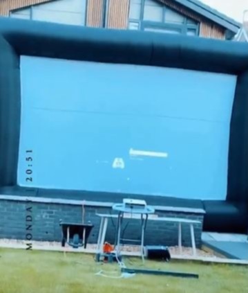 She set up a giant screen across the back of her house