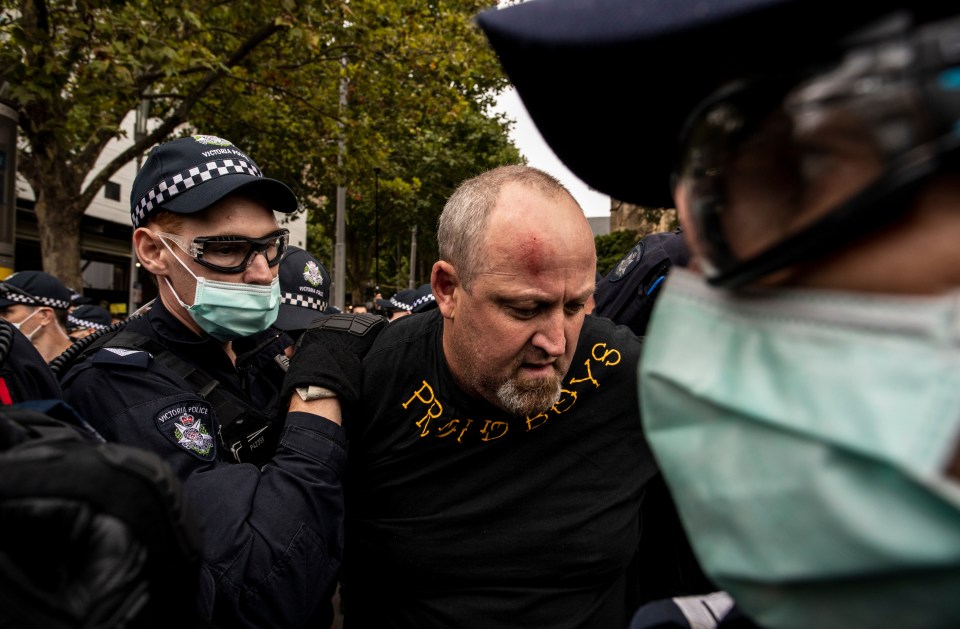 A member of the Proud Boys is arrested during protests on Australia Day