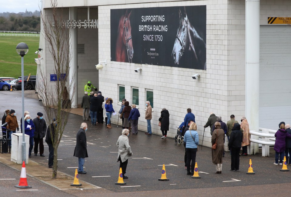 Brits queue today to receive their Covid-19 vaccine at the centre that has been set up at Epsom Racecourse, Surrey