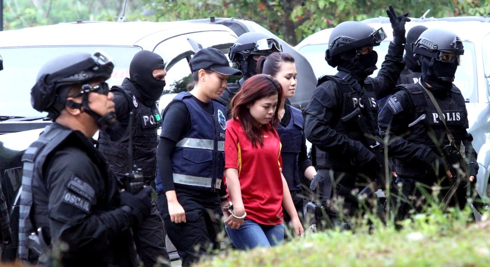 Siti being taken into court under the protection of special armed forces - her charges were eventually dropped 