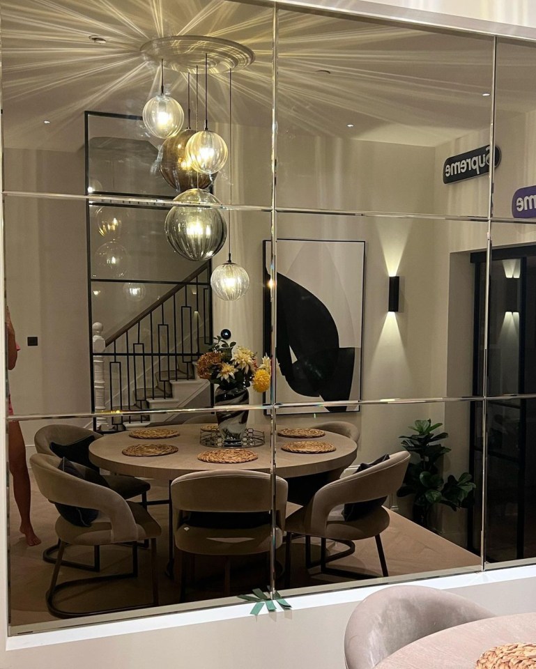 The home’s dining area features a stunning mirrored wall