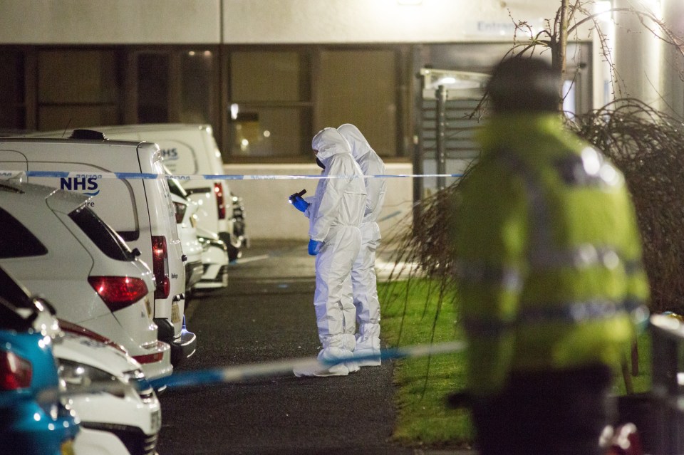 Forensics workers investigate the scene of a stabbing in Kilmarnock