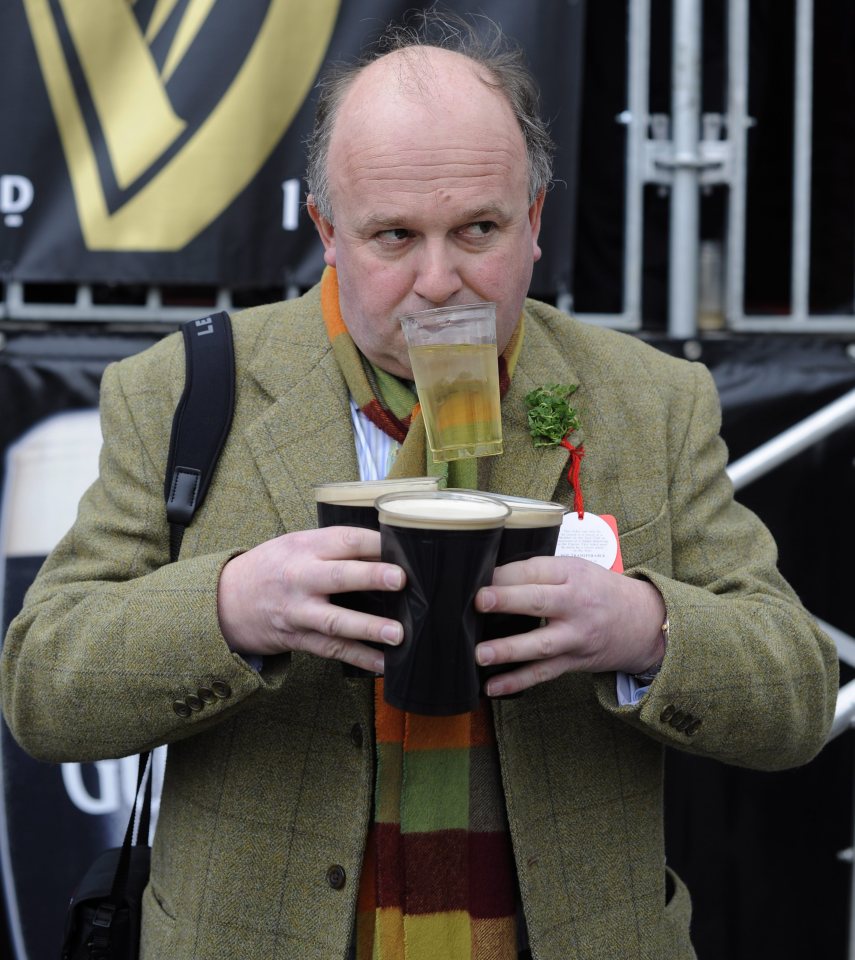 A punter manages to carry three pints of Guinness and a glass of white wine in his mouth