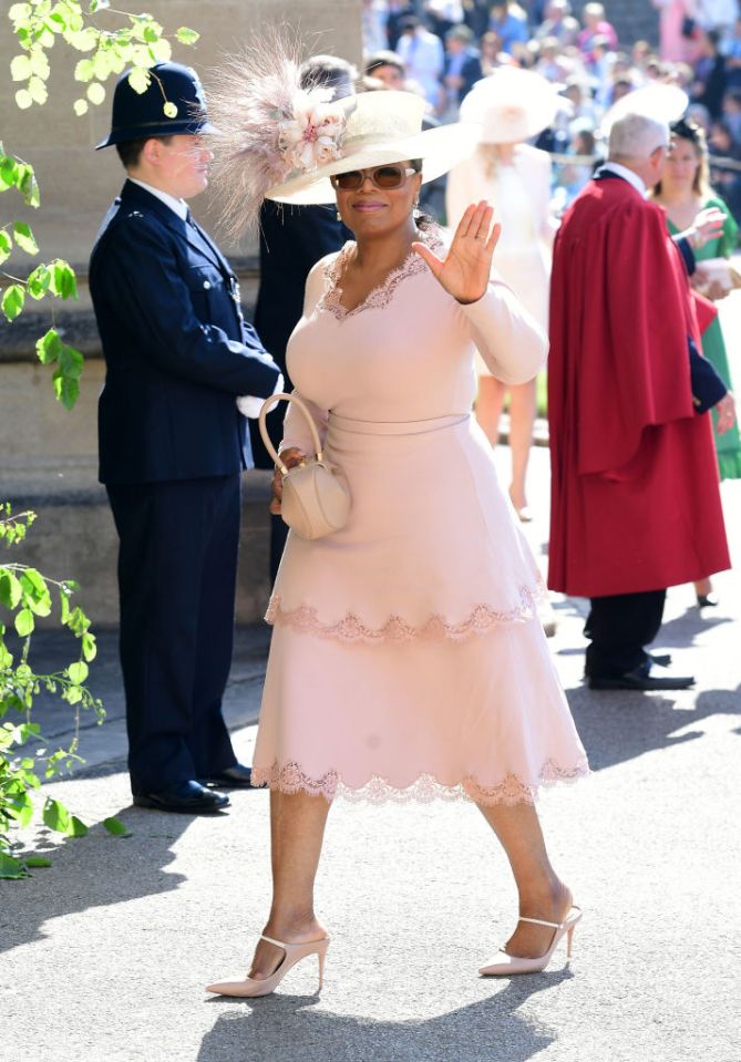 TV host Oprah Winfrey waves at Meghan and Harry's wedding