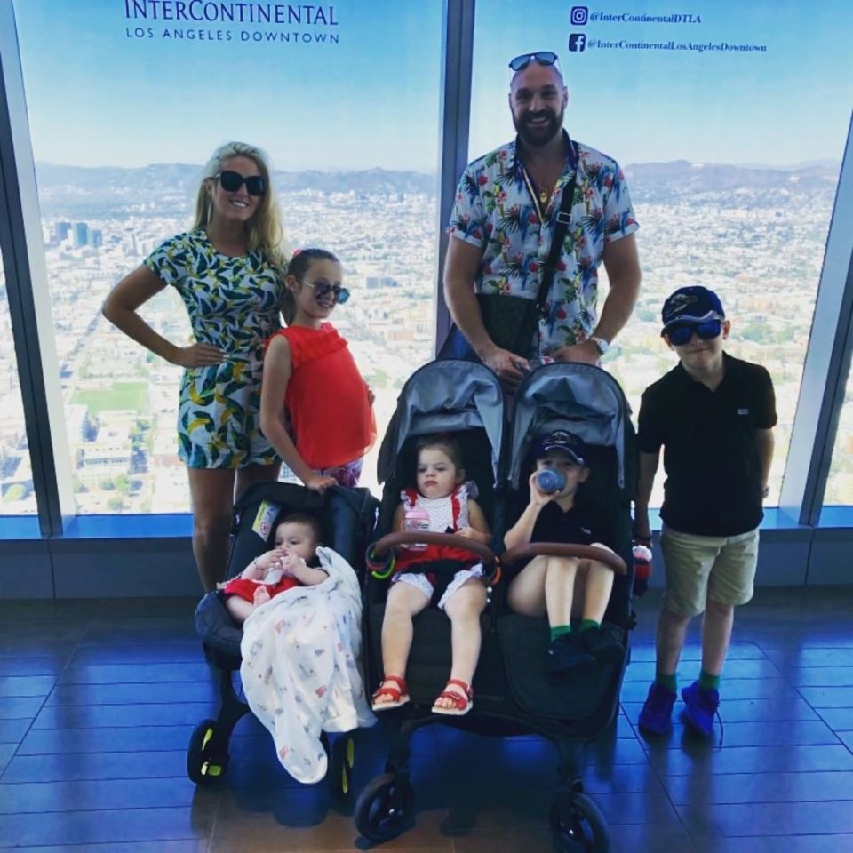 a family poses in front of a sign that says intercontinental los angeles downtown