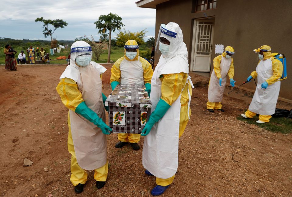 Healthcare workers carry a coffin with a baby, who died from Ebola, in the Democratic Republic of Congo