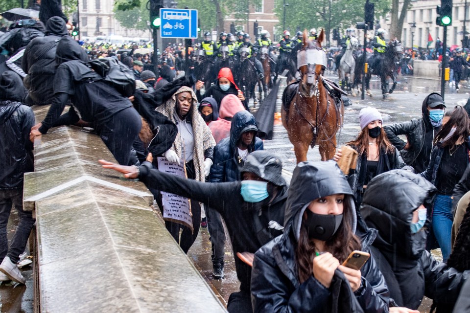 People run for cover as a police horse runs wild on Whitehall after its rider came off in June 2020