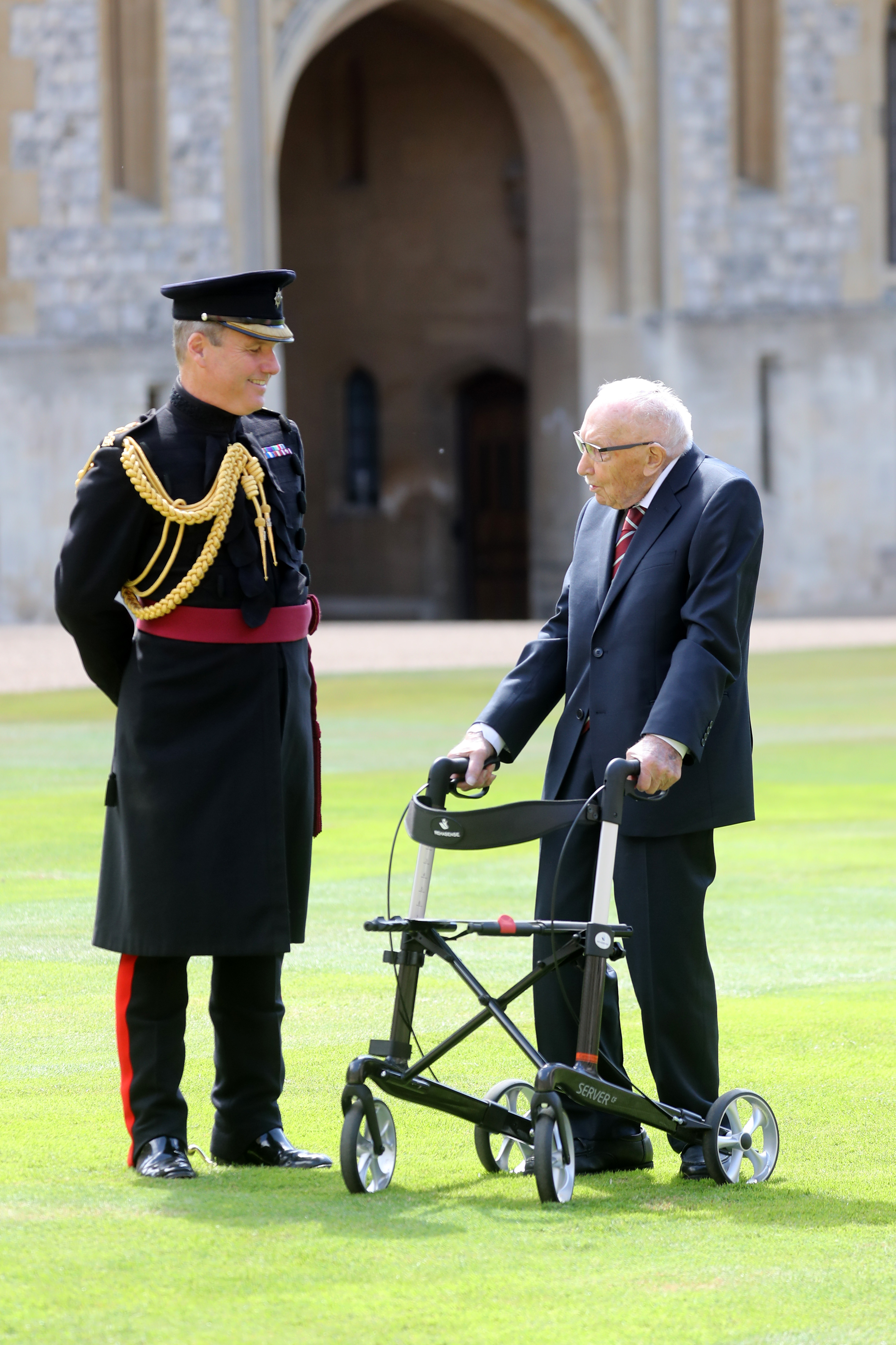 The 100-year-old is battling coronavirus in Bedford hospital. Pictured: Captain Tom on the day of his knighting in Windsor