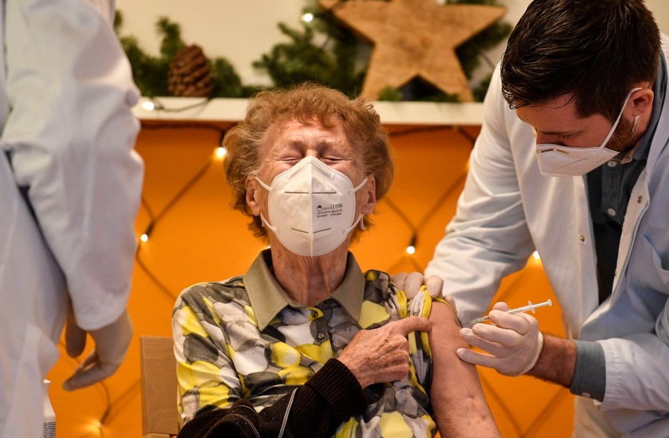 A resident of a nursing home gets the Covid-19 vaccine in Cologne, Germany