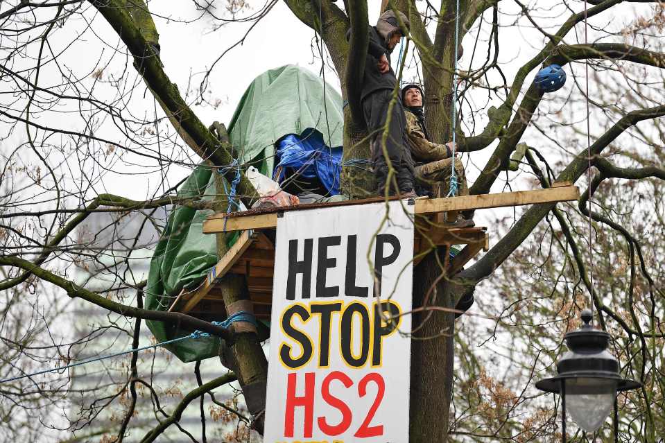 Activists stand in tree houses at their protest camp near Euston railway station