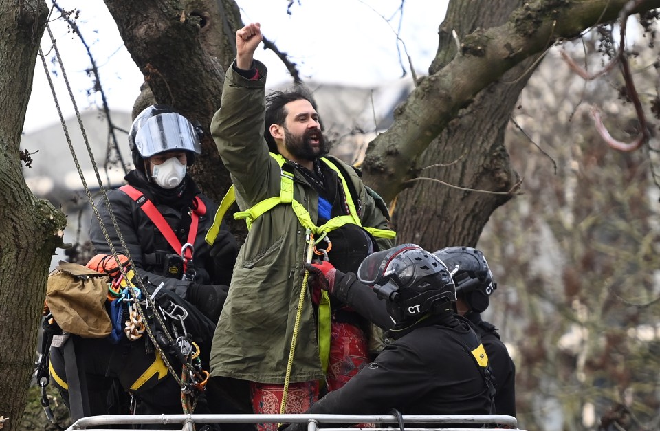 Police arrest a HS2 Rebellion protester from a camp at Euston Square in London