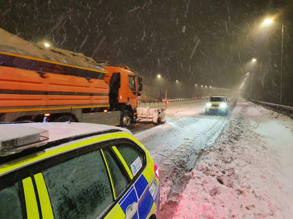 A gritter lorry battles through the snow on the M62 motorway in West Yorkshire