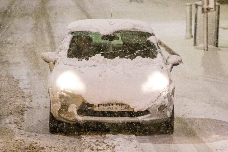 A motorist braves the snow this morning in Leeds, Yorkshire