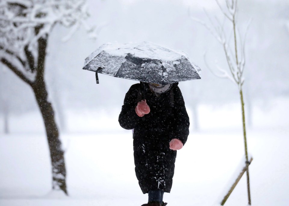 A man walks through heavy snowfall in Harrogate, Yorkshire