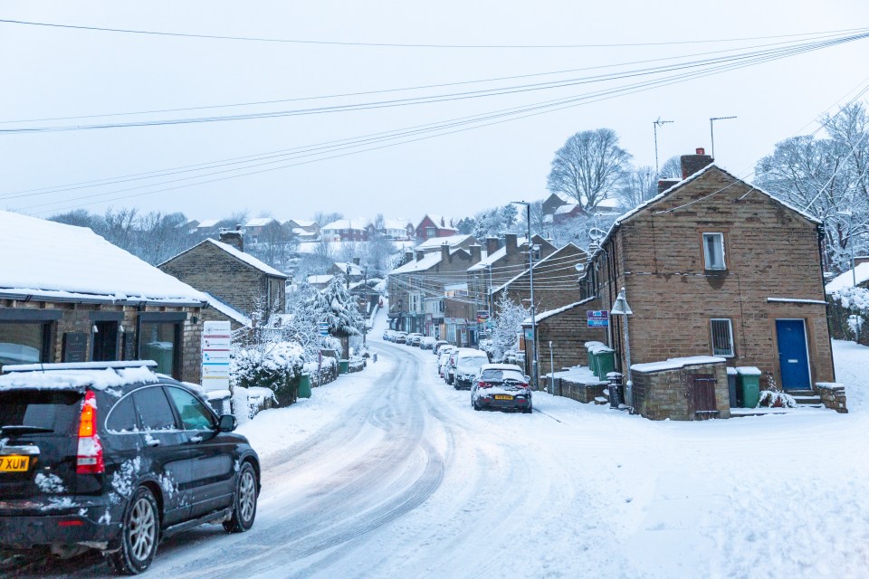 Villagers venture to work in their vehicles amid heavy snow fall in Kirkburton near Huddersfield