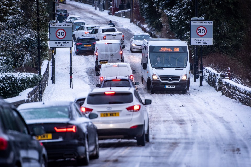 Vehicles get stuck on an icy road in Denshaw Village, Greater Manchester, this morning