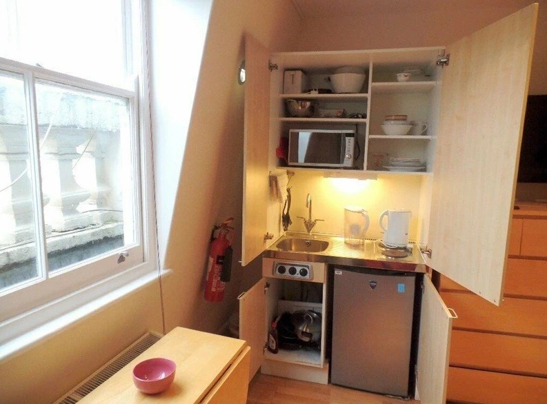 The kitchen is inside a cupboard - and only has a microwave to cook with