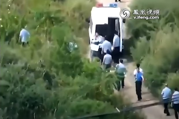 Pictures allegedly showing a man with a placard hanging round his neck due to be killed in a public execution in China