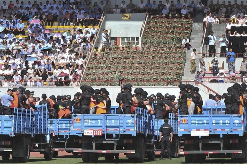 The public sentencing of 55 people in a stadium - with some of them carted off to be killed