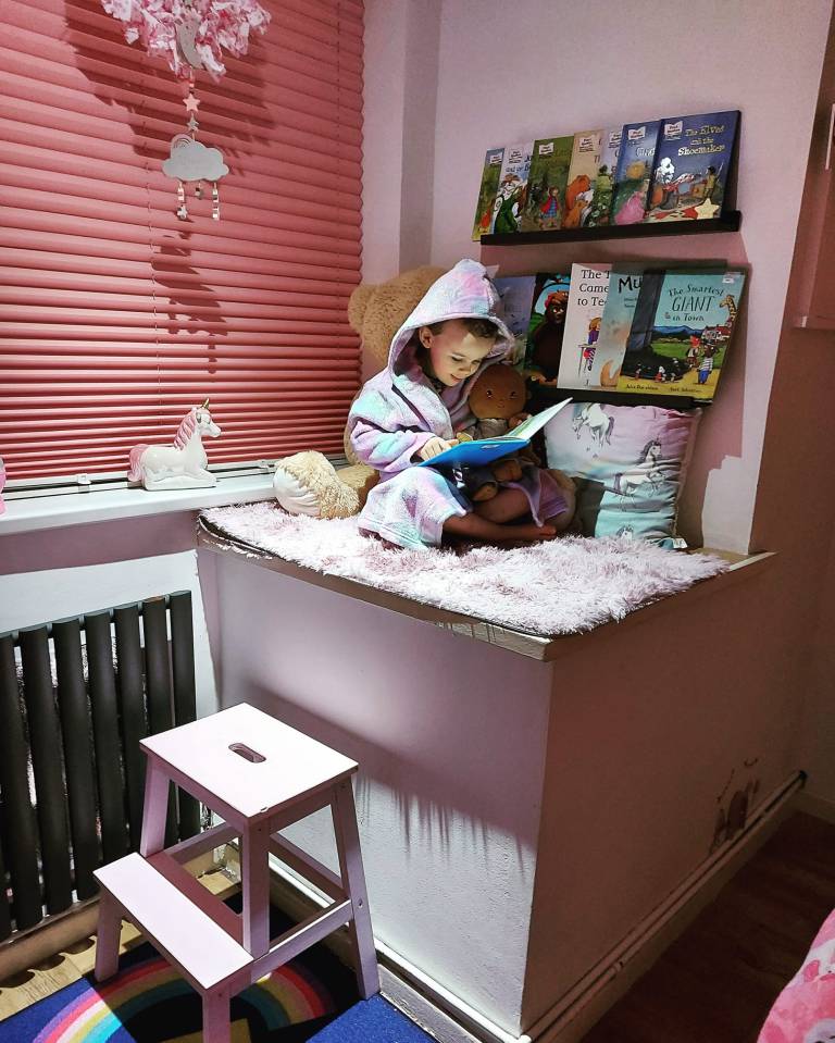 Emma Nelson transformed her "awkward" box over the stairs into a sweet reading nook for her daughter