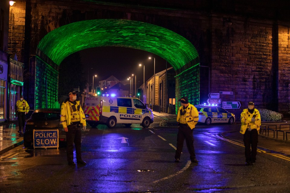 Police stand at Portland Street that is closed to the public as they carry out their investigation