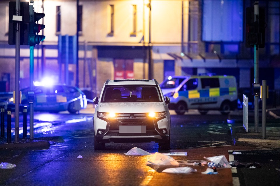 Detectives erected a cordon, inside which a white Mitsubishi vehicle could be seen under an arch with its hazard lights flashing