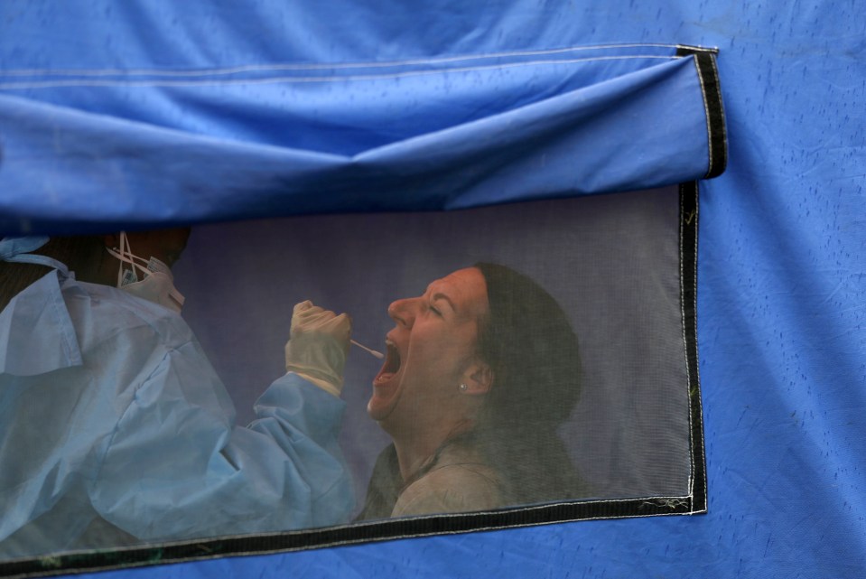 A woman undergoes a Covid test in Lenasia, South Africa