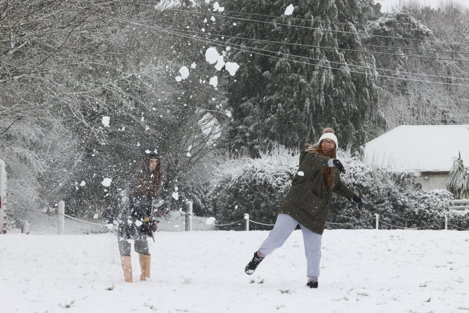 Vicky Ives and her daughter Molly, 12, playing in the snow near their home in the village of Coldred in Kent