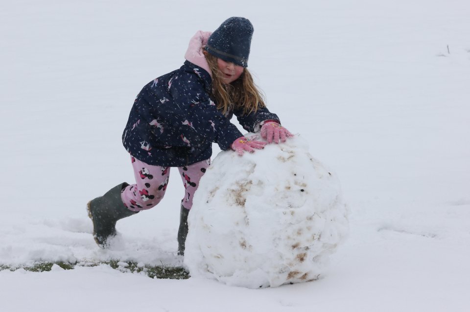 A little girl in Lydden, Kent, makes the most of the snow