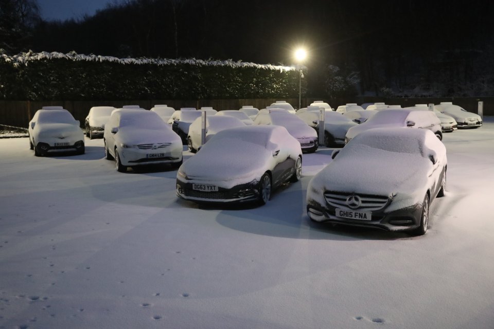 Cars at a showroom near Detling in Kent were buried under thick snow