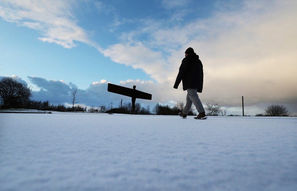 A walker enjoys a view of the Angel of the North in Gateshead