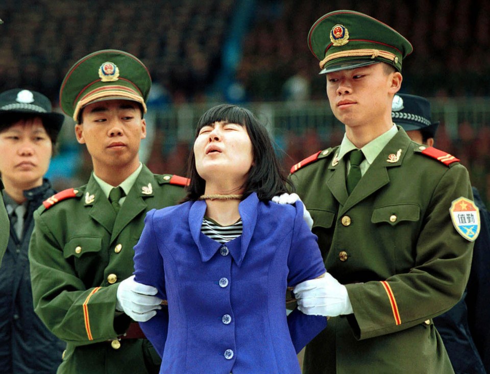 A woman, convicted of murder, shouts as she hears the verdict before being taken to be executed in China