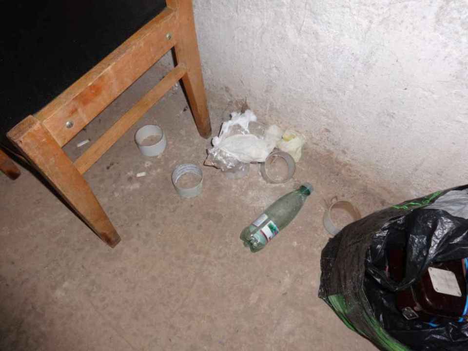 Used rolls of tape and bottled water can be seen on the floor