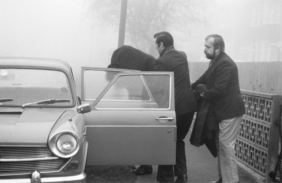 Flying Squad chief Kenneth Drury is escorted from his home in Kent after his arrest in 1976