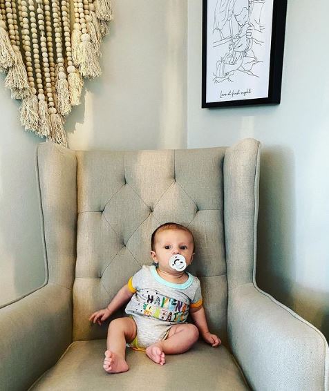 Baby Oliver takes a seat on the huge armchair