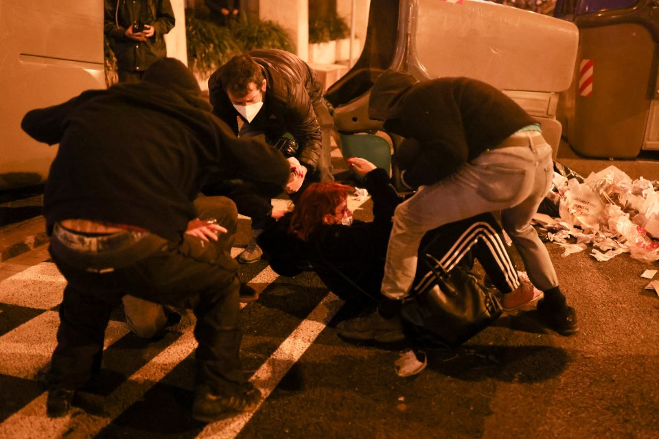 An injured protester is helped by others in Barcelona