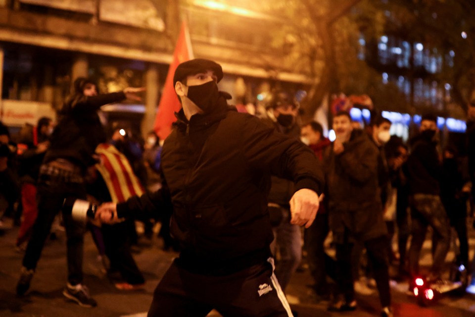 Protesters throw bottles at police at a demo in Barcelona last night