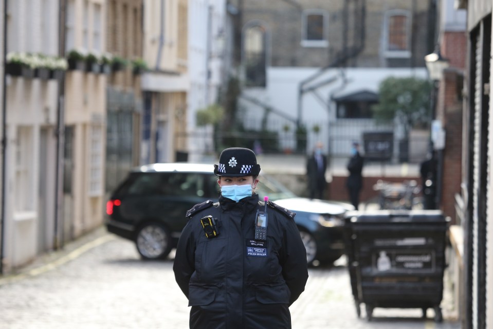 A police officer stands by the hospital where Prince Philip is being cared for