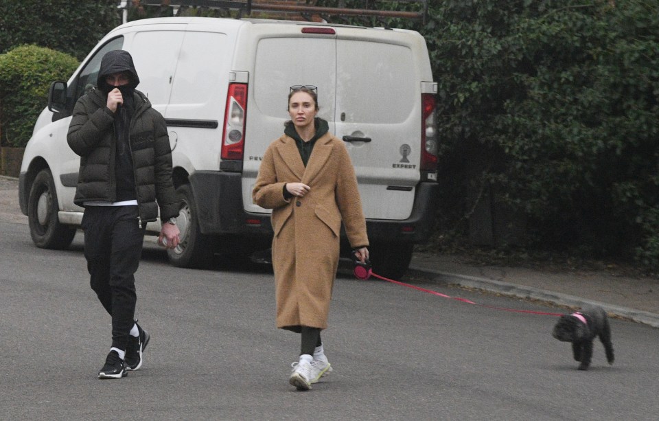 But covered up his branded cap with his hoodie as they couple went on a stroll with Megan's dog Daisy